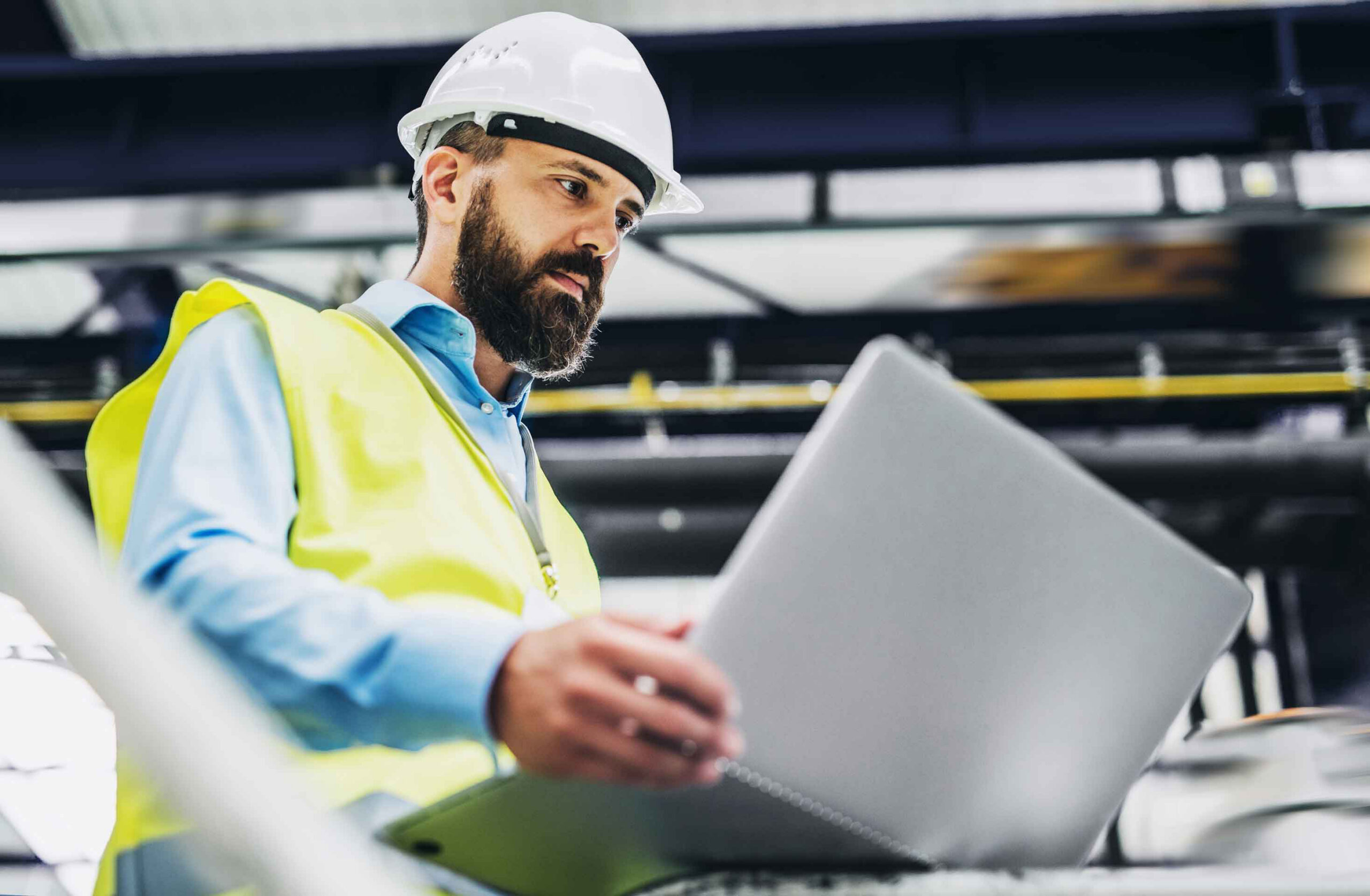 Operator reviewing PM Studio on a plant-floor laptop