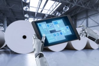 processminer-changing-pulp-and-paper-digital-tech AI looking at production data in front of large paper reams